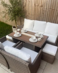 Outlet Beliani Set salotto da giardino con tavolo e pouf 5 posti FONTI con cuscini Rattan sintetico (PE) Marrone Bianco Marrone
