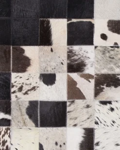 Sale Beliani Tappeto KEMAH Nero 140 x 200 cm Pelle naturale Bianco Nero
